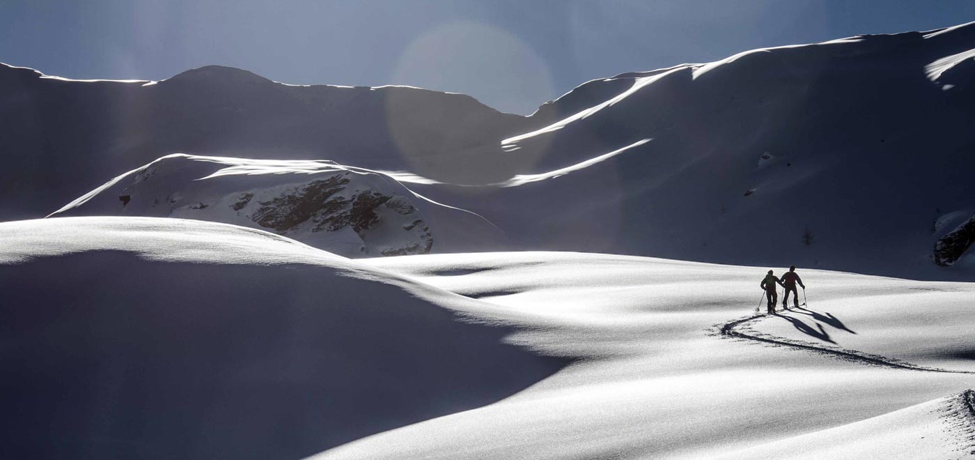 Two alpine skiers in the beautiful setting of a snowy mountain in Veneto