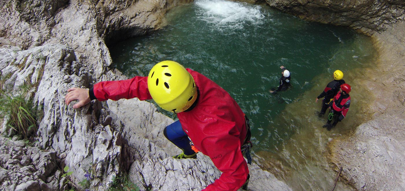Hikers doing canyoning in the river Brenta
